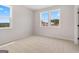 Sunlit bedroom with plush carpet, large windows, and neutral tones at 7530 W Homer Dr, Cumming, GA 30028