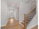 Welcoming entryway with light wood floors and staircase leading to the second floor at 7530 W Homer Dr, Cumming, GA 30028