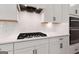Modern kitchen with stainless steel appliances and gas stove, with white cabinetry and ample counter space at 7530 W Homer Dr, Cumming, GA 30028