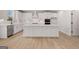 Bright, open-concept kitchen features a large island, stainless steel appliances, and modern white cabinetry at 7530 W Homer Dr, Cumming, GA 30028
