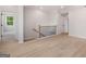 Upstairs landing area with natural light, wood floors, and staircase view at 7530 W Homer Dr, Cumming, GA 30028
