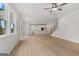 Spacious living room with light wood floors that connects to the kitchen area at 7530 W Homer Dr, Cumming, GA 30028