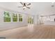 Open-concept living space with kitchen, large windows, and sliding doors to the outdoors at 7530 W Homer Dr, Cumming, GA 30028