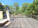 Large wooden back deck with lounge, overlooks landscaped yard and pool area at 910 Lilac Arbor Rd, Dacula, GA 30019