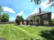 Landscaped backyard featuring a lush lawn and mature trees at 910 Lilac Arbor Rd, Dacula, GA 30019