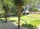 Backyard view of a treehouse and play set at 910 Lilac Arbor Rd, Dacula, GA 30019