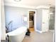 Luxurious bathroom with a freestanding tub and a separate glass enclosed shower at 910 Lilac Arbor Rd, Dacula, GA 30019