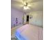 Spacious bedroom features a ceiling fan and floral wall decals at 910 Lilac Arbor Rd, Dacula, GA 30019