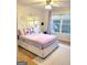 Bright bedroom features a large window, ceiling fan, and comfortable queen bed at 910 Lilac Arbor Rd, Dacula, GA 30019