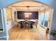 Formal dining room features hardwood floors, wainscoting and a stylish light fixture at 910 Lilac Arbor Rd, Dacula, GA 30019