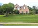 Charming two-story brick home with well-manicured lawn and mature landscaping at 910 Lilac Arbor Rd, Dacula, GA 30019
