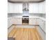 Modern kitchen with stainless steel appliances, white cabinets, and a stylish backsplash at 910 Lilac Arbor Rd, Dacula, GA 30019