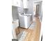 Laundry room with washer, dryer, utility sink, and hardwood floors at 910 Lilac Arbor Rd, Dacula, GA 30019