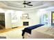 Main bedroom featuring a cozy fireplace, access to the balcony, and light hardwood floors at 910 Lilac Arbor Rd, Dacula, GA 30019