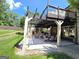 Covered patio with outdoor seating, fireplace, and a view of the backyard at 910 Lilac Arbor Rd, Dacula, GA 30019