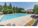 Community pool with lounge chairs and shade trees at 910 Lilac Arbor Rd, Dacula, GA 30019