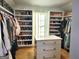 Walk-in closet featuring custom shelving and ample storage space at 910 Lilac Arbor Rd, Dacula, GA 30019