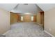Spacious bonus room with neutral carpet, warm paint, and a small window at 204 Eleanor Court, Stockbridge, GA 30281