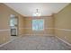 Dining room with neutral carpet, chandelier and window overlooking the backyard at 204 Eleanor Court, Stockbridge, GA 30281