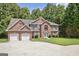 Charming two-story brick home with a well-manicured lawn and attached two car garage at 204 Eleanor Court, Stockbridge, GA 30281