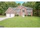 Charming two-story brick home with a well-manicured lawn and attached two car garage at 204 Eleanor Court, Stockbridge, GA 30281