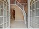 Bright, inviting foyer with tile floors, a staircase, and double doors to the exterior at 204 Eleanor Court, Stockbridge, GA 30281