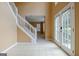 Bright tiled foyer with white staircase, and large double doors with glass panes at 204 Eleanor Court, Stockbridge, GA 30281