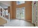 Inviting foyer with tile floors and double doors to the exterior and staircase at 204 Eleanor Court, Stockbridge, GA 30281
