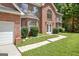 A beautifully maintained, two-story brick home with a well-manicured lawn at 204 Eleanor Court, Stockbridge, GA 30281