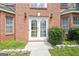 Close up of the double white front door with glass inserts of a red brick home at 204 Eleanor Court, Stockbridge, GA 30281