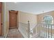 Upstairs hallway with railing and chandelier at 204 Eleanor Court, Stockbridge, GA 30281