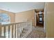 Hallway with neutral carpet, white railing, and lots of natural light from the large window at 204 Eleanor Court, Stockbridge, GA 30281