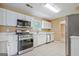 Modern kitchen with stainless steel appliances, ample counter space and tile floor at 204 Eleanor Court, Stockbridge, GA 30281