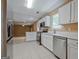Modern kitchen featuring stainless steel appliances, white cabinets, and tiled flooring at 204 Eleanor Court, Stockbridge, GA 30281