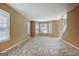 Sunlit living room featuring neutral carpet and multiple windows at 204 Eleanor Court, Stockbridge, GA 30281