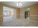 Open-concept living room showcases neutral carpet and views of the kitchen and staircase at 204 Eleanor Court, Stockbridge, GA 30281