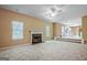 Spacious living room showcasing a fireplace, carpet flooring, and plenty of natural light at 204 Eleanor Court, Stockbridge, GA 30281