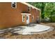 Brick home featuring a walkout concrete patio and fenced backyard at 1783 Cheyenne Trl, Jonesboro, GA 30236