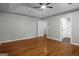 A bedroom has hardwood floors, gray walls, white trim and white doors leading to closet and ensuite bathroom at 1783 Cheyenne Trl, Jonesboro, GA 30236