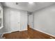 A bedroom features hardwood floors, gray walls, white trim and white doors leading to closet and other rooms at 1783 Cheyenne Trl, Jonesboro, GA 30236