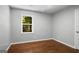 A bedroom includes hardwood floors, gray walls, white trim and a window with natural light at 1783 Cheyenne Trl, Jonesboro, GA 30236