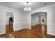 Elegant dining room featuring hardwood floors, wainscotting, and chandelier at 1783 Cheyenne Trl, Jonesboro, GA 30236