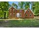 Charming brick two-story home with a symmetrical facade and a lush green lawn at 1783 Cheyenne Trl, Jonesboro, GA 30236