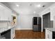Modern kitchen with granite countertops, stainless refrigerator, and white cabinetry at 1783 Cheyenne Trl, Jonesboro, GA 30236