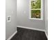 Practical laundry room with dark wood floors and a window for ample natural light at 1783 Cheyenne Trl, Jonesboro, GA 30236