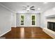 Spacious living room featuring hardwood floors, a fireplace, and natural light at 1783 Cheyenne Trl, Jonesboro, GA 30236