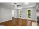 Light-filled living room featuring a ceiling fan, hardwood floors, and two windows at 1783 Cheyenne Trl, Jonesboro, GA 30236