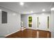 Living room with hardwood floors, natural light, and stairs to the second floor at 1783 Cheyenne Trl, Jonesboro, GA 30236