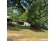 Large backyard featuring a covered storage structure and open green space at 213 Whipporwill Way, Riverdale, GA 30274