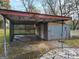 Open carport with metal siding and lattice, providing covered parking and storage space at 213 Whipporwill Way, Riverdale, GA 30274